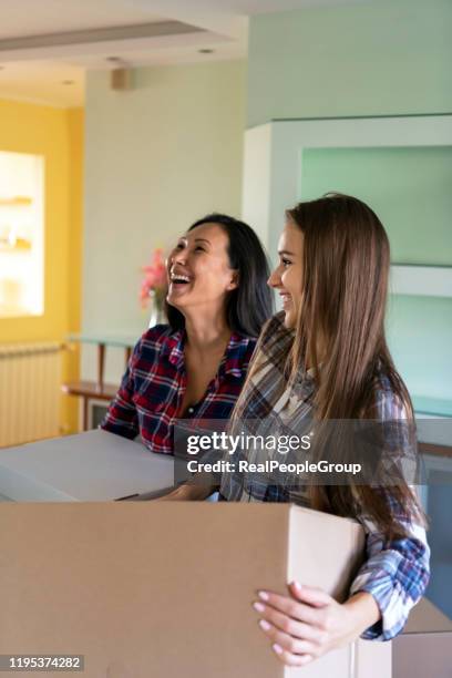 young lesbian couple is entering a new home - embracing change stock pictures, royalty-free photos & images