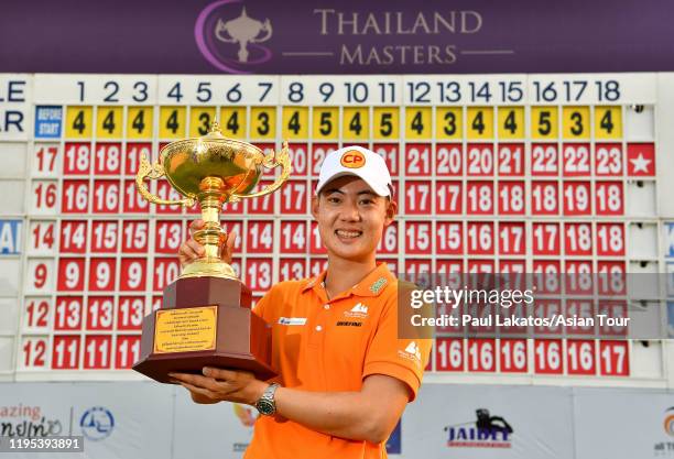 Jazz Janewattananond of thailand celebrates with the winner's trophy at Phoenix Gold Golf & Country Club on December 20, 2019 in Pattaya, Thailand.