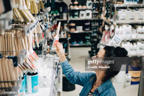 high angle view of senior woman shopping in hardware store - hardware shop stock pictures, royalty-free photos & images