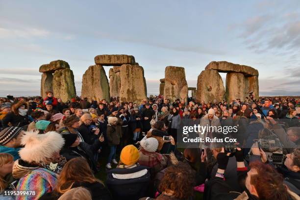 Revellers take part in celebrations to mark the winter solstice at Stonehenge prehistoric monument on December 22, 2019 in Wiltshire, England....