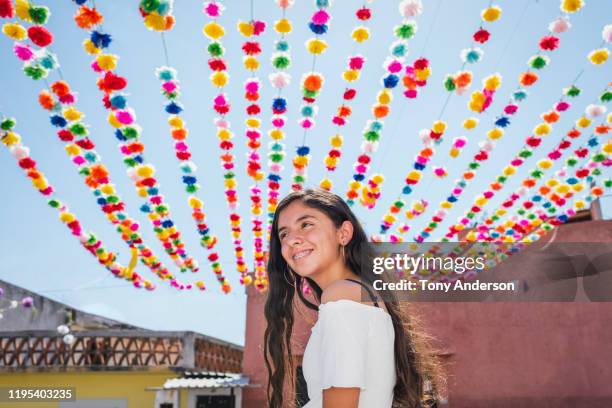 teenage girl walking on street decorated for festival - traditional festival bildbanksfoton och bilder