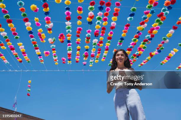 teenage girl on street that's decorated for a festival - traditional festival imagens e fotografias de stock