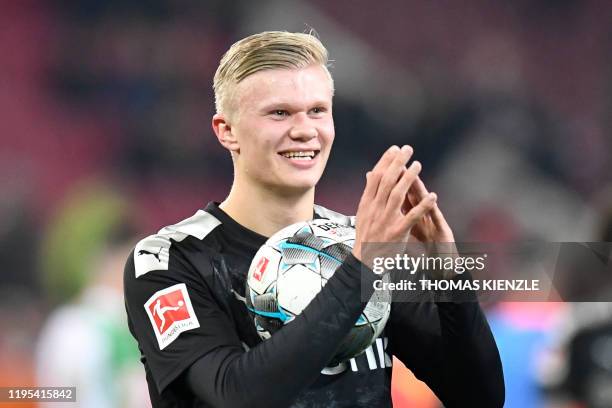 In this file photo taken on January 18, 2020 Dortmund's Norwegian forward Erling Braut Haaland smiles as he holds the match ball after his team's 5-3...