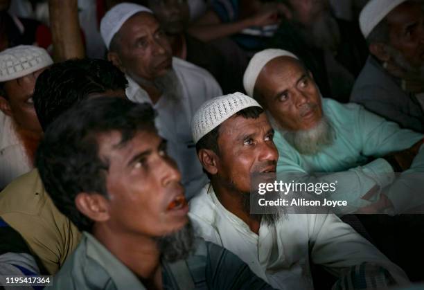 People watch the ICJ hearing at a restaurant in a Rohingya refugee camp on January 23, 2020 in Cox's Bazar, Bangladesh. On Thursday, the...