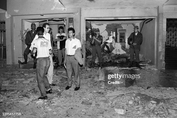 Soldiers stand guard in front of the Radio Colmundo studios, on May 24, 1990 in Medellin, after a bomb attack, before the presidential elections...