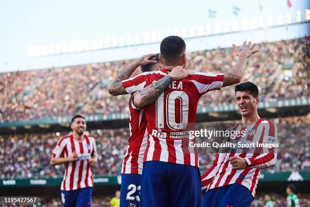 Alvaro Morata of Atletico de Madrid celebrates scoring his team's second goal with team mates during the Liga match between Real Betis Balompie and...