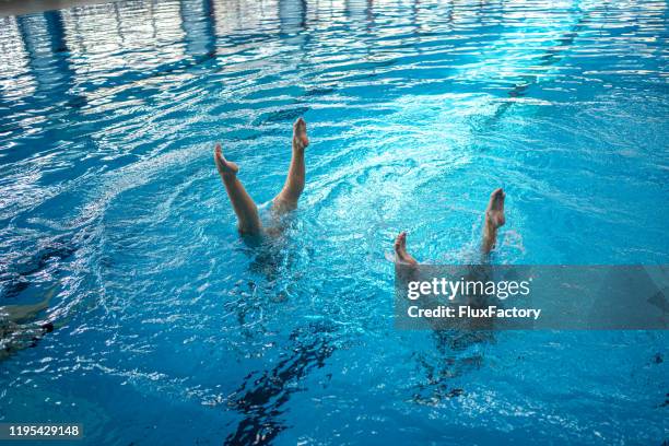 synchronized swimming duet - synchronized swimming stock pictures, royalty-free photos & images