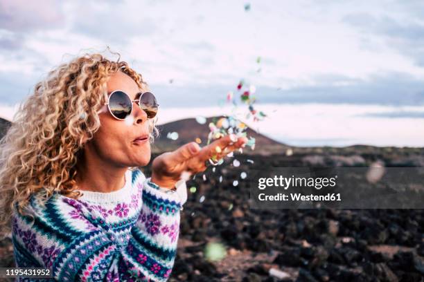 blond woman blowing confetti in the air, tenerife, spain - balloon woman party stock pictures, royalty-free photos & images