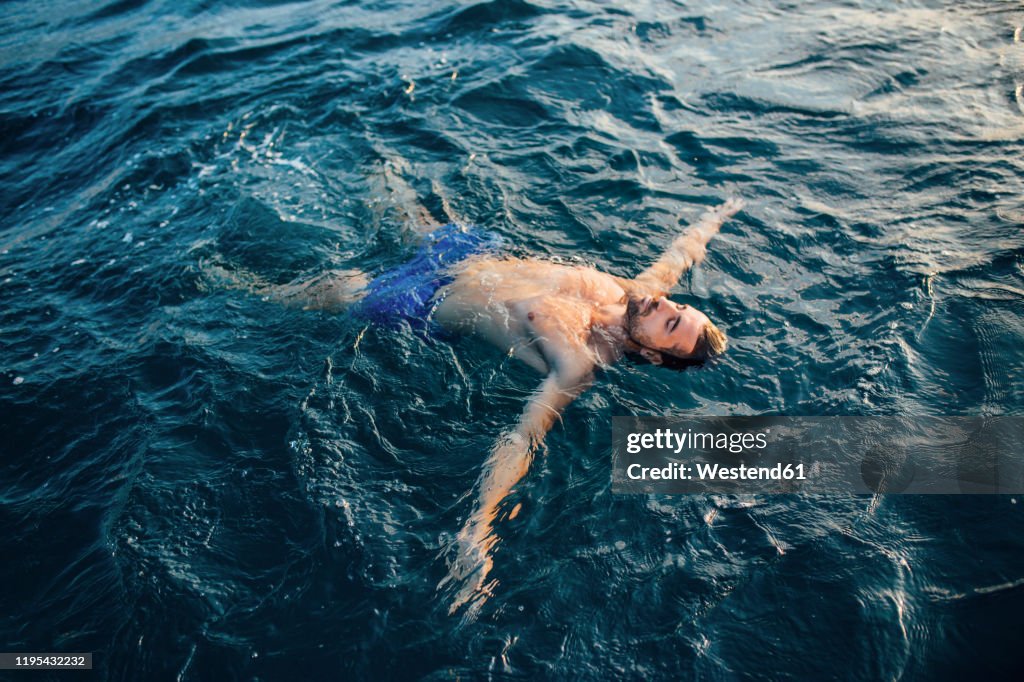 Young man floating on water