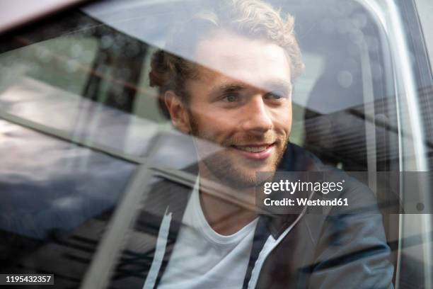 young man getting out of the car - white car stock pictures, royalty-free photos & images