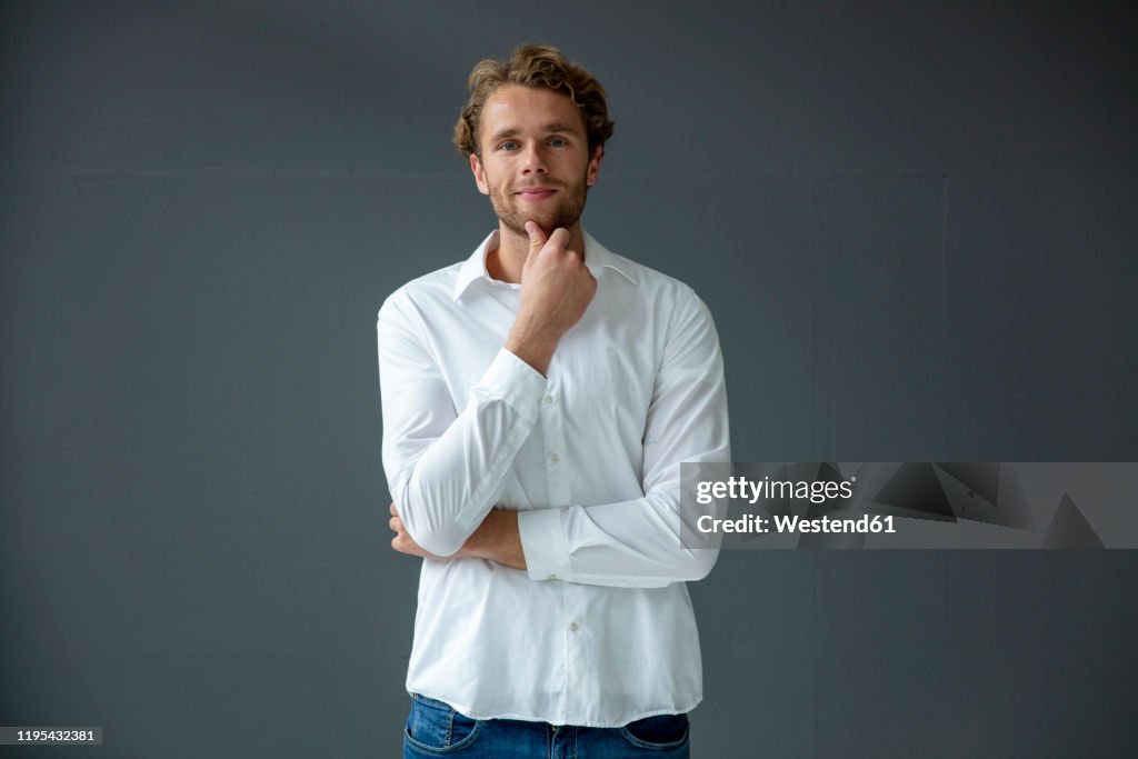 Portrait of young businessman, wearing white shirt