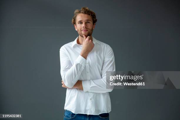 portrait of young businessman, wearing white shirt - man hand on chin stock pictures, royalty-free photos & images