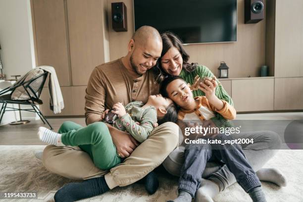 family with two kids - families meeting inside stock pictures, royalty-free photos & images