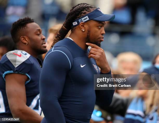 Running back Derrick Henry of the Tennessee Titans on the sidelines out of uniform prior to the start of the game against the New Orleans Saints in...