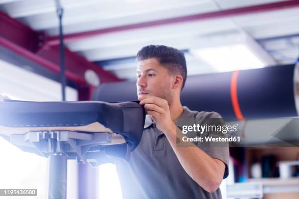 young man working in a upholstery workshop - upholstery worker stock pictures, royalty-free photos & images