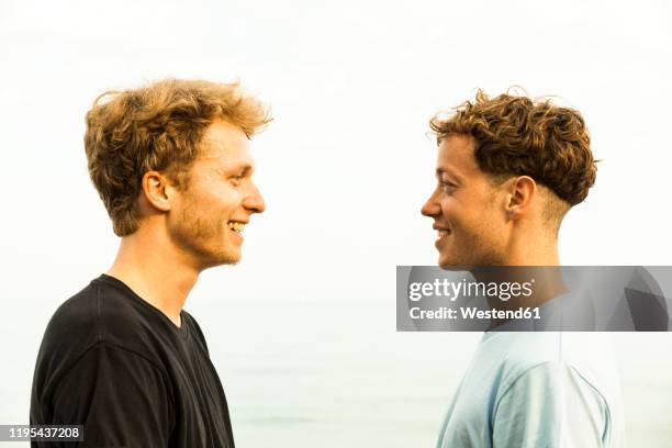 portrait of strawberry blonde young men, face to face - irony stock pictures, royalty-free photos & images