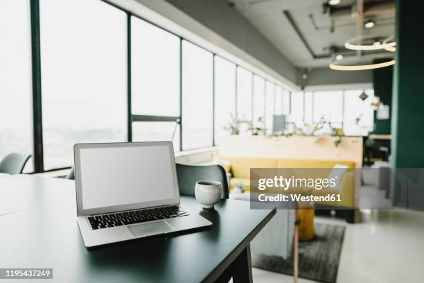 business, laptop and cup in coworking office - office sofa stock-fotos und bilder