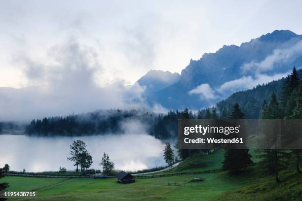 germany, bavaria, mittenwald, misty morning at lautersee lake - karwendel stock-fotos und bilder