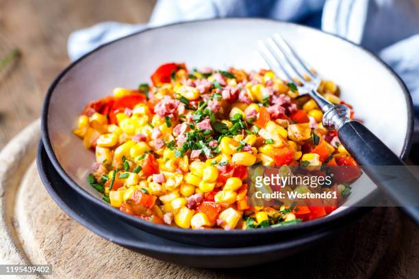 bowl of warm corn salad with bell pepper, potatoes and diced ham† - mache stock pictures, royalty-free photos & images