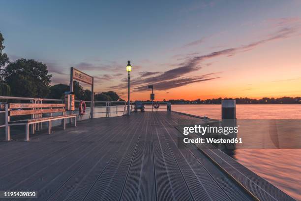 germany, hamburg, pier on outer alster lake at sunrise - alster lake stock pictures, royalty-free photos & images