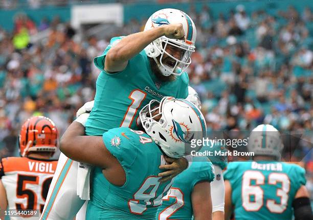 Ryan Fitzpatrick and Christian Wilkins of the Miami Dolphins celebrate touchdown against the Cincinnati Bengals in the first quarter at Hard Rock...