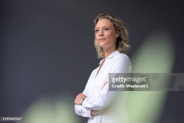 young businesswoman wearing white shirt looking sideways - looking away stock-fotos und bilder