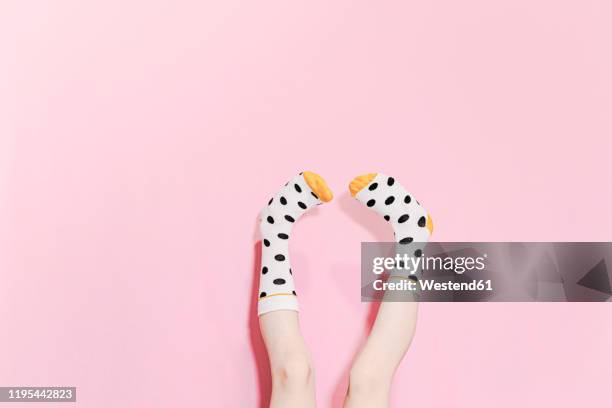 legs of a girl wearing dotted socks - monochrome clothing stock-fotos und bilder