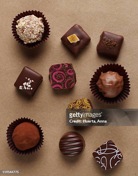 chocolates on brown background - chocolate truffles stock pictures, royalty-free photos & images
