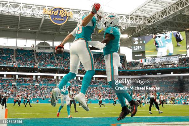 Mike Gesicki of the Miami Dolphins celebrates with DeVante Parker after a touchdown against the Cincinnati Bengals during the second quarter at Hard...