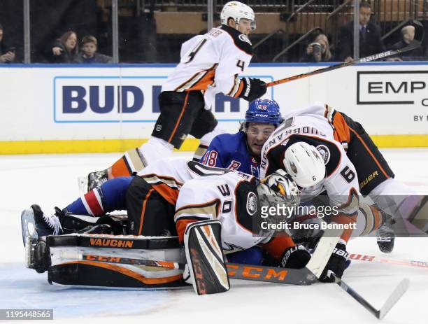 Ryan Miller and Erik Gudbranson of the Anaheim Ducks defend against Brendan Lemieux of the New York Rangers during the second period at Madison...