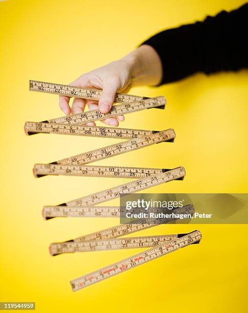 woman holding tape measure - duimstok stockfoto's en -beelden