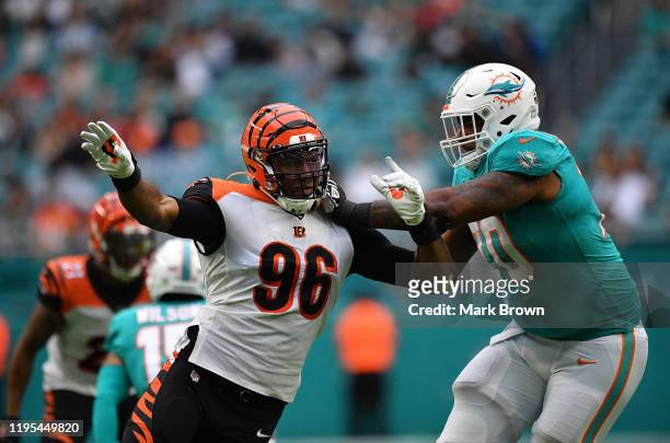Carlos Dunlap of the Cincinnati Bengals rushes the passer against Julie'n Davenport of the Miami Dolphins in the first quarter at Hard Rock Stadium...