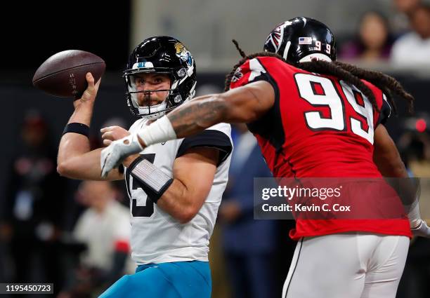 Gardner Minshew II of the Jacksonville Jaguars looks to pass as he is pressured by Adrian Clayborn of the Atlanta Falcons in the first half at...