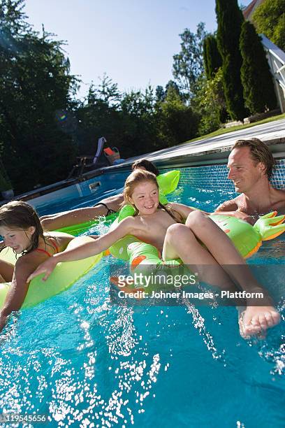family playing in swimming pool - preteen girl no shirt stock pictures, royalty-free photos & images