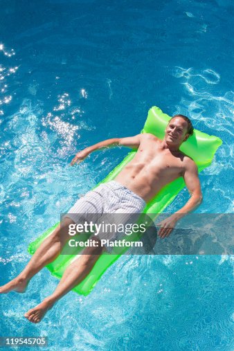 Guy On Inflatable Raft Man On Inflatable Raft In Swimming Pool High-Res Stock Photo - Getty Images