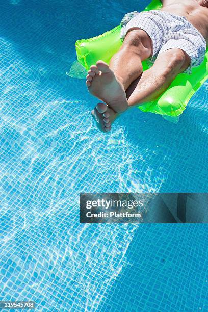 Guy On Inflatable Raft Man On Inflatable Raft In Swimming Pool High-Res Stock Photo - Getty Images