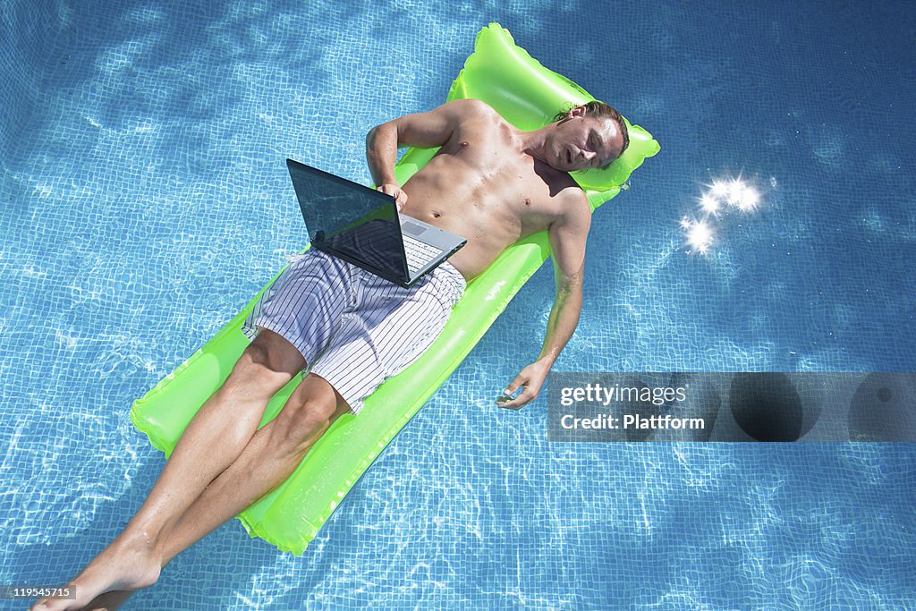 Guy On Inflatable Raft Man Floating On Inflatable Raft With Laptop And Sleeping High-Res Stock ...
