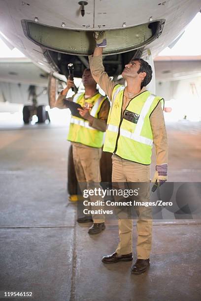 aircraft workers checking airplane - wheel well stock pictures, royalty-free photos & images