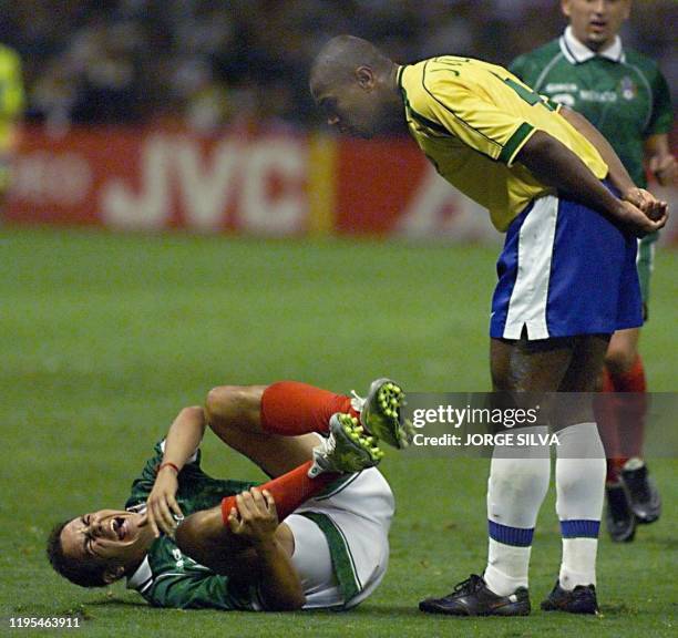 Cuauhtemoc Blanco of Mexico screams after Joao Carlos of Brazil fouled him 04 August 1999 during the final game of the Confederations Cup in Mexico...