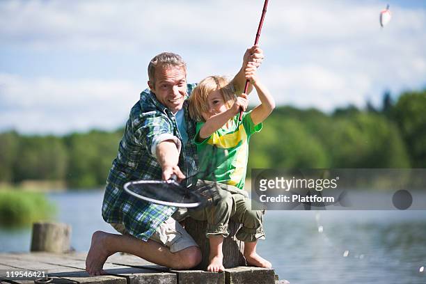 father and son fishing - freshwater fishing stock photos et images de collection