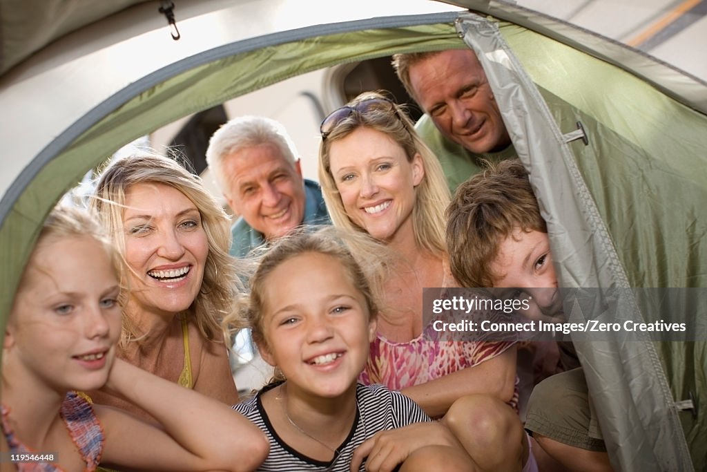 Family peering into camping tent