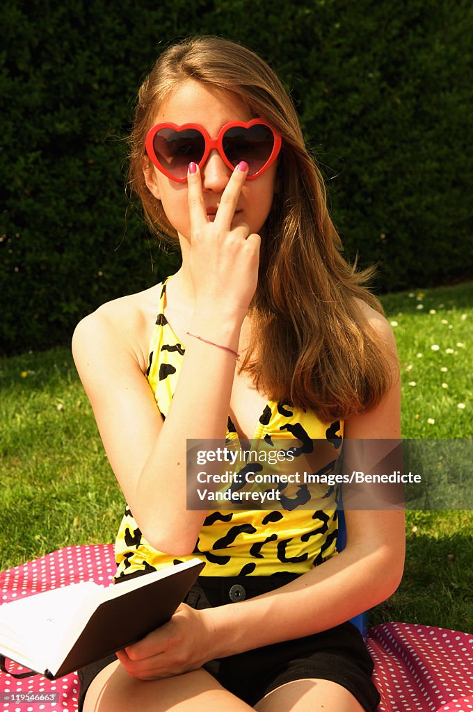 Girl wearing heart sunglasses