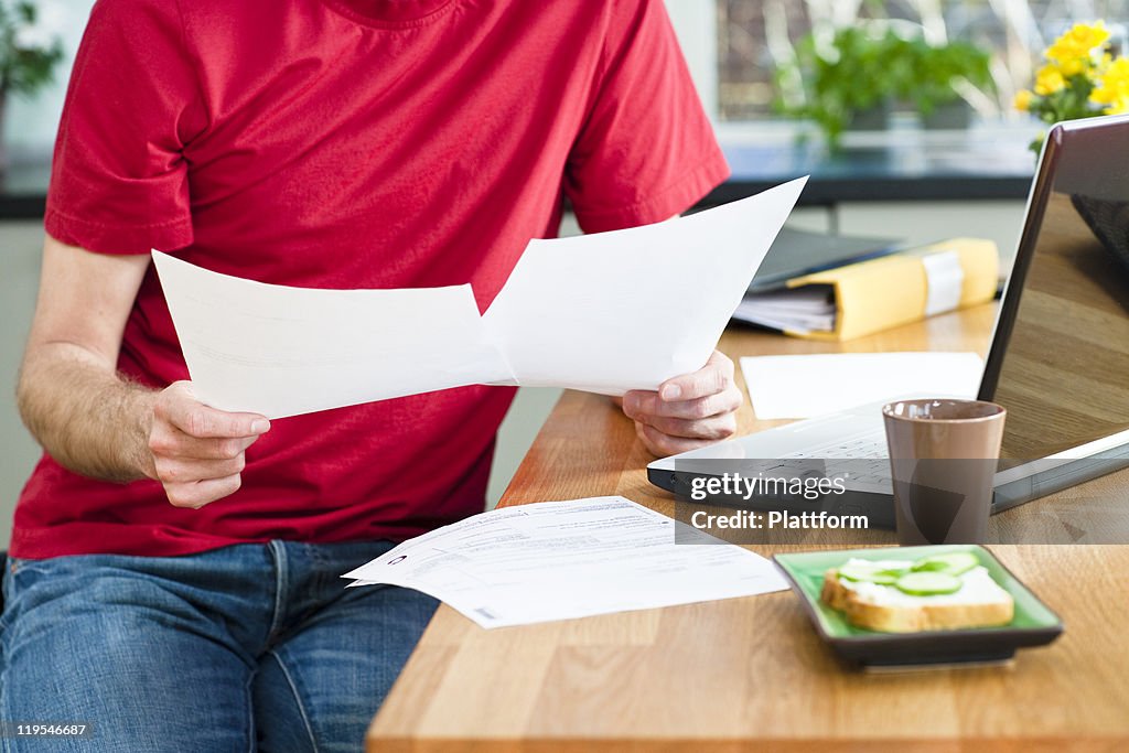 Mid section of man working from home