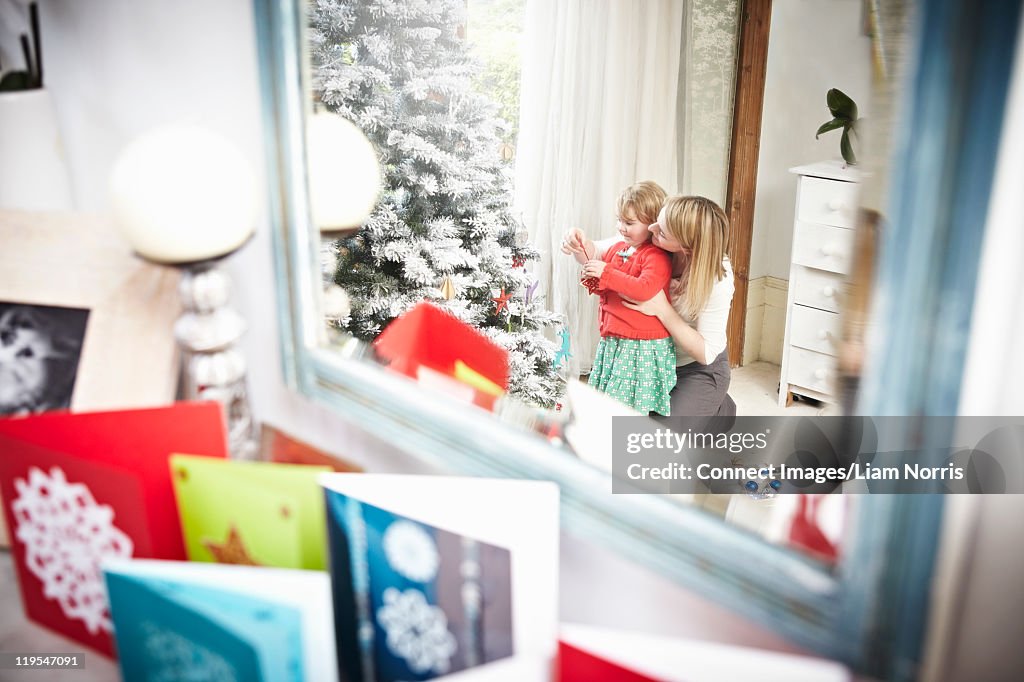 Mother and daughter with Christmas tree