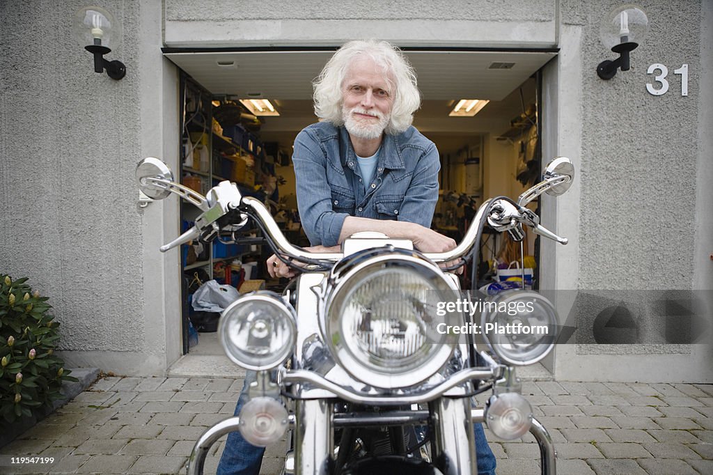 Portrait of senior man on vintage motorbike