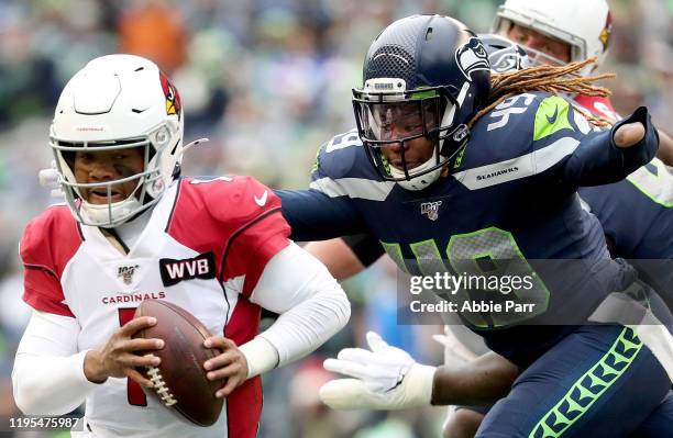 Quarterback Kyler Murray of the Arizona Cardinals scrambles against pressure from outside linebacker Shaquem Griffin of the Seattle Seahawks during...