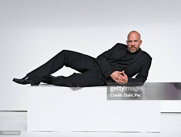man against white background, portrait - lying on side stock-fotos und bilder