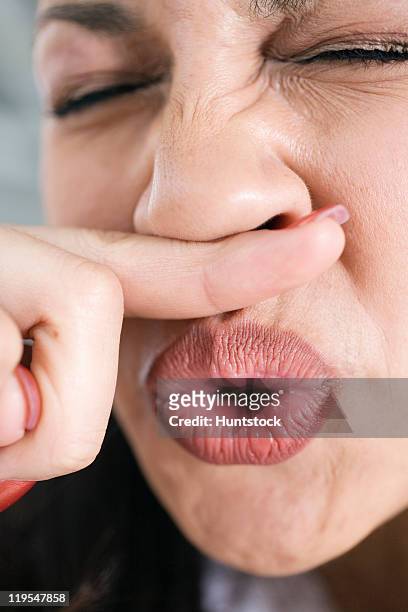 close-up of a hispanic woman sneezing - closeup of a hispanic woman sneezing foto e immagini stock