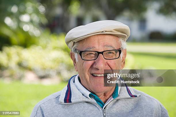 portrait of a senior man smiling - flat cap stock pictures, royalty-free photos & images