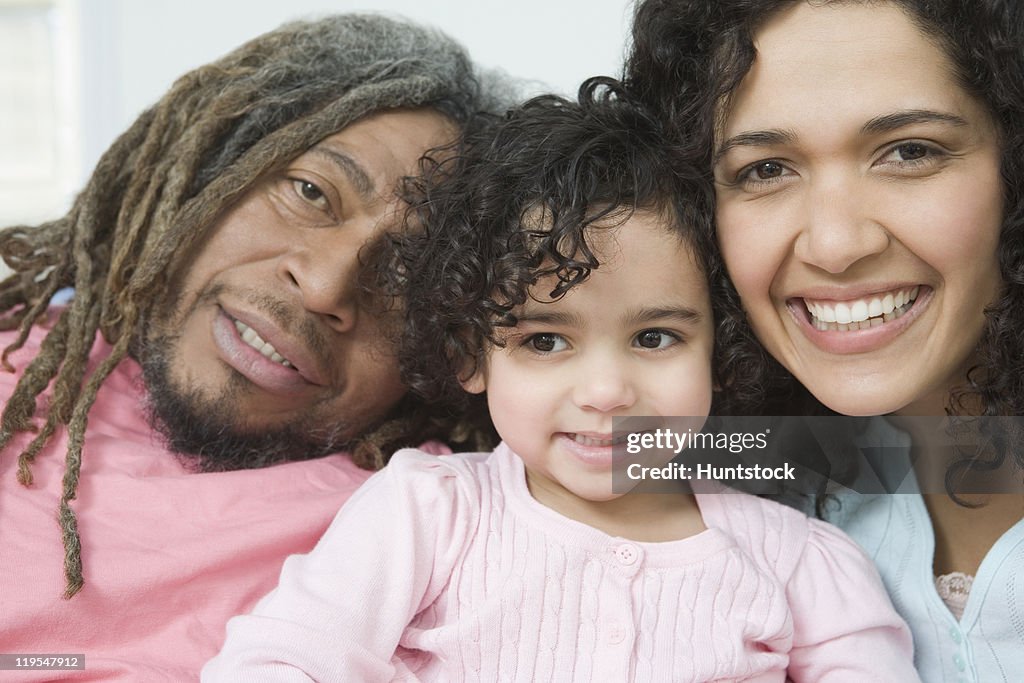 Close-up of a Hispanic girl smiling with her parents